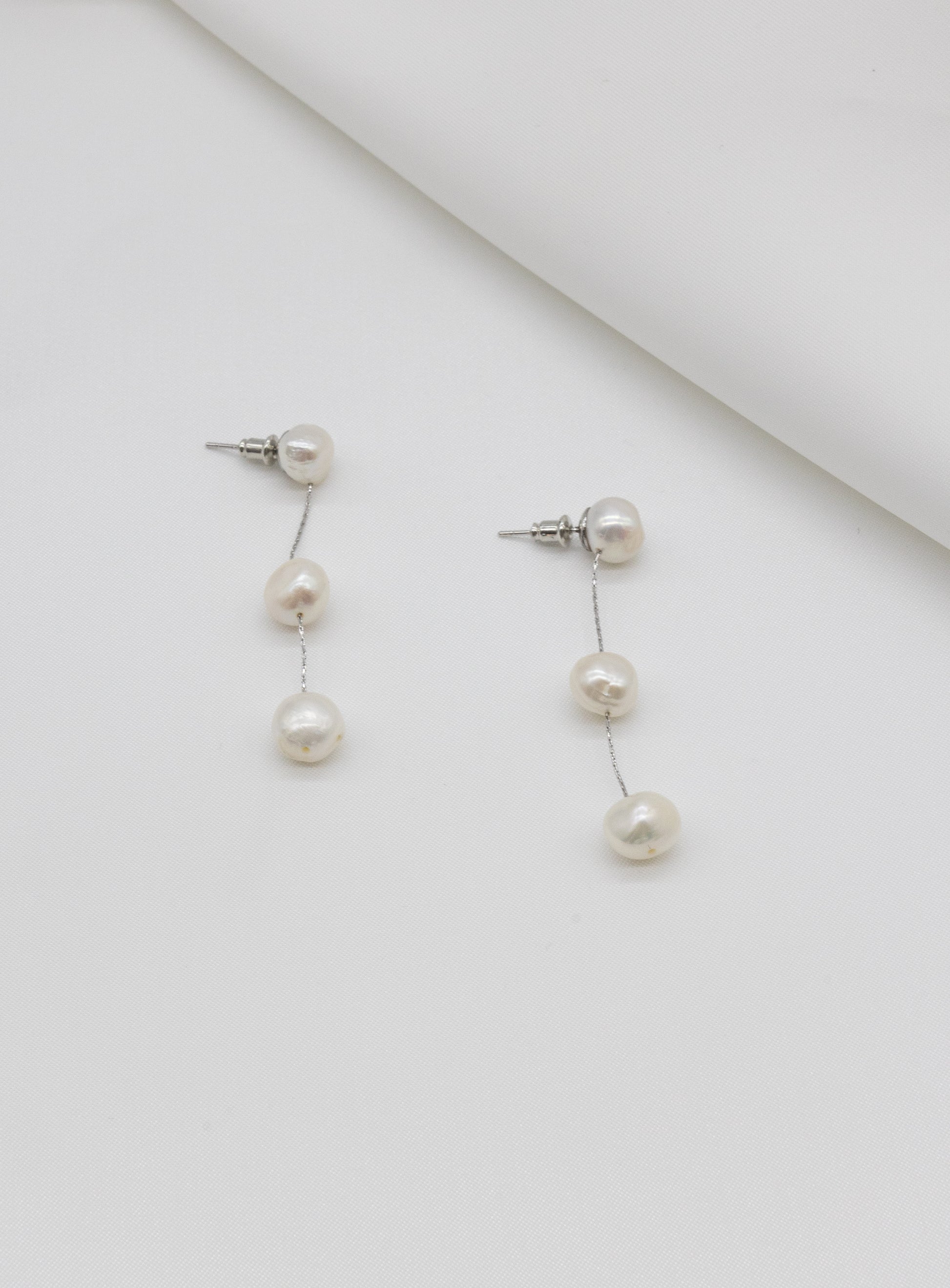 walk the aisle silver freshwater pearl bridal earrings on a clean bridal jewellery background