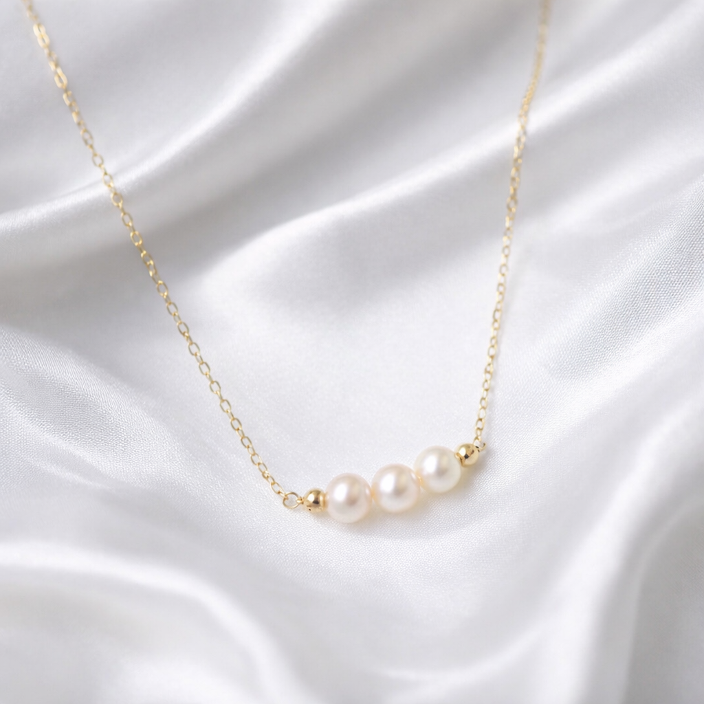 Aspen freshwater pearl gold necklace on a clean bridal jewellery background
