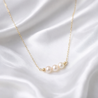 Aspen freshwater pearl gold necklace on a clean bridal jewellery background
